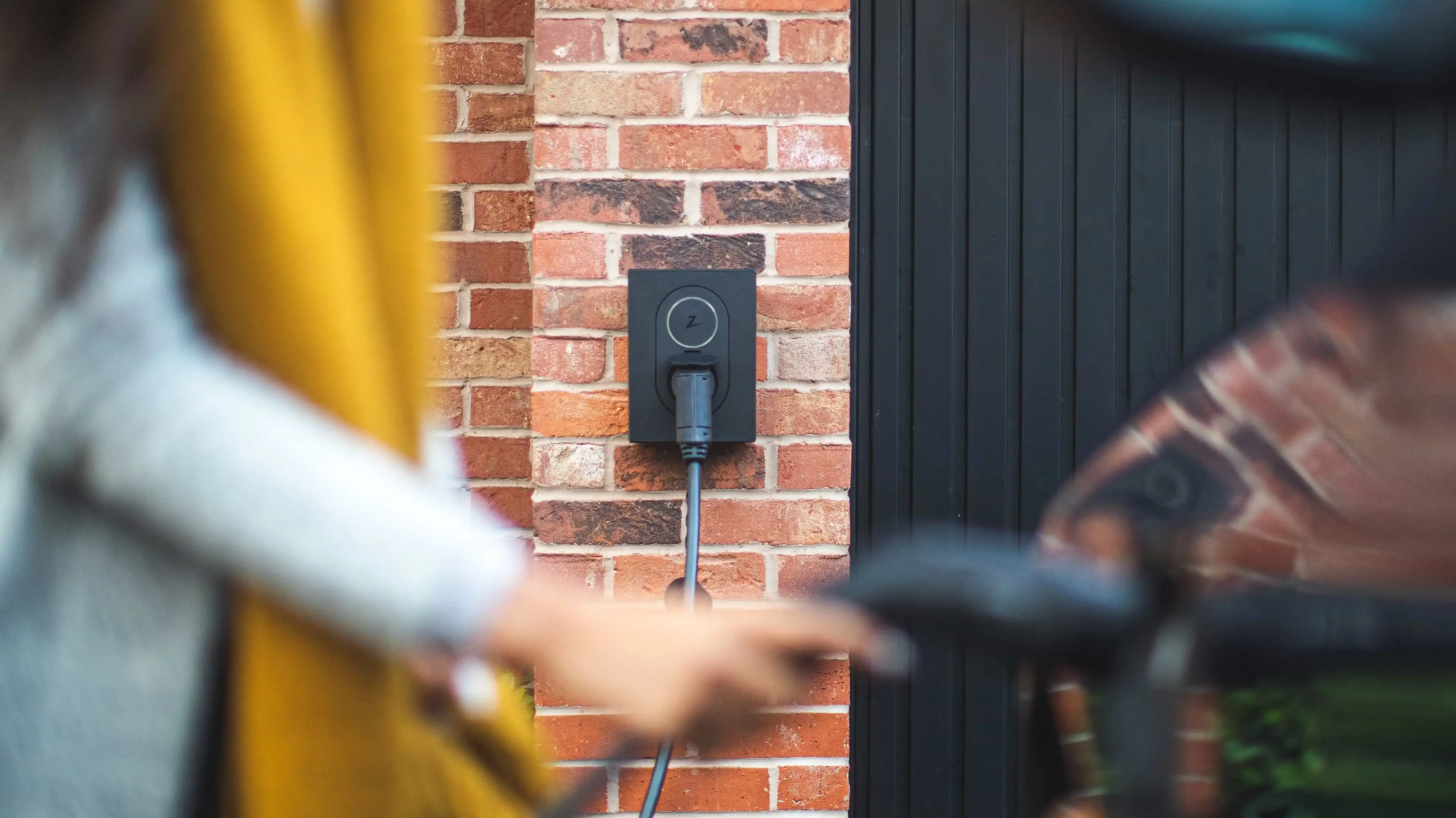 image of a homeowner using an electric vehicle charging station they've had installed at their home. Credit: Zaptec Charging Solutions credit: Zaptec home charging